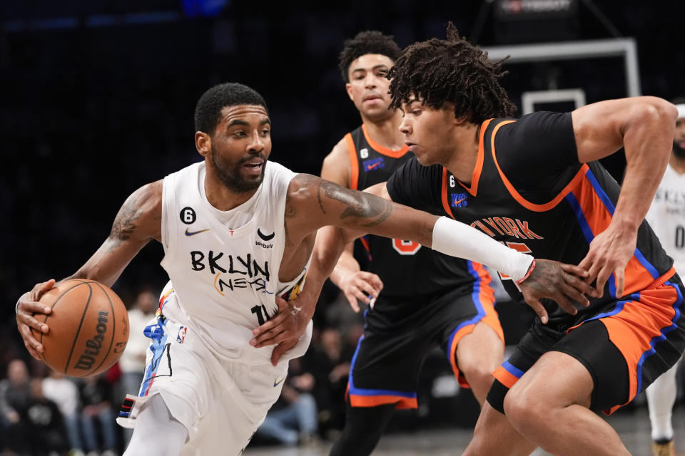 Brooklyn Nets guard Kyrie Irving (11) drives against New York Knicks center Jericho Sims during the second half of an NBA basketball game, Saturday, Jan. 28, 2023, in New York. The Nets won 122-115. (AP Photo/Mary Altaffer)