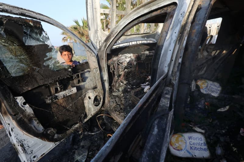 Palestinians inspect the heavily damaged vehicle after the Israeli attacks target officials working ta the US-based international volunteer aid organization World Central Kitchen (WCK). Omar Ashtawy/APA Images via ZUMA Press Wire/dpa