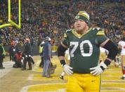 Jan 5, 2014; Green Bay, WI, USA; Green Bay Packers guard T.J. Lang (70) walks off the field after the San Francisco 49ers beat the Packers 23-20 during the 2013 NFC wild card playoff football game at Lambeau Field. Mandatory Credit: Benny Sieu-USA TODAY Sports