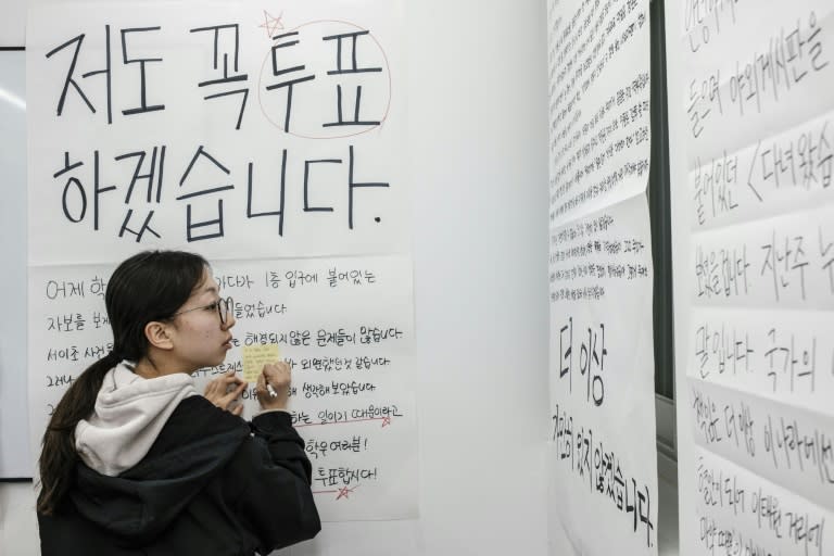 A woman looks at posters during an event about the importance of youth voting in South Korea before Wednesday's election (ANTHONY WALLACE)