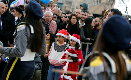 People attend Christmas celebrations at Manger Square outside the Church of the Nativity in Bethlehem, in the Israeli-occupied West Bank December 24, 2018. REUTERS/Raneen Sawafta