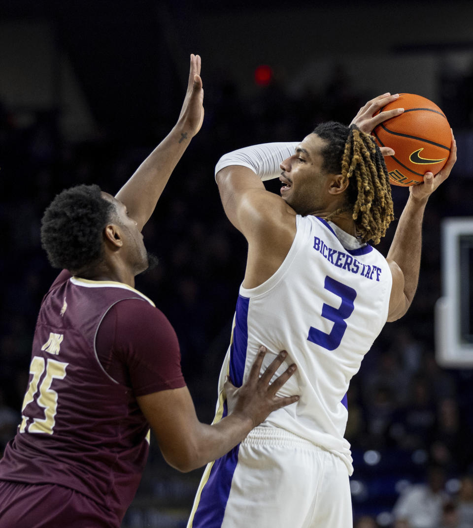 James Madison forward T.J. Bickerstaff (3) looks for an opening against Texas State forward Chris Nix (25) during the second half of an NCAA college basketball game in Harrisonburg, Va., Saturday, Dec. 30, 2023. (Daniel Lin/Daily News-Record via AP)
