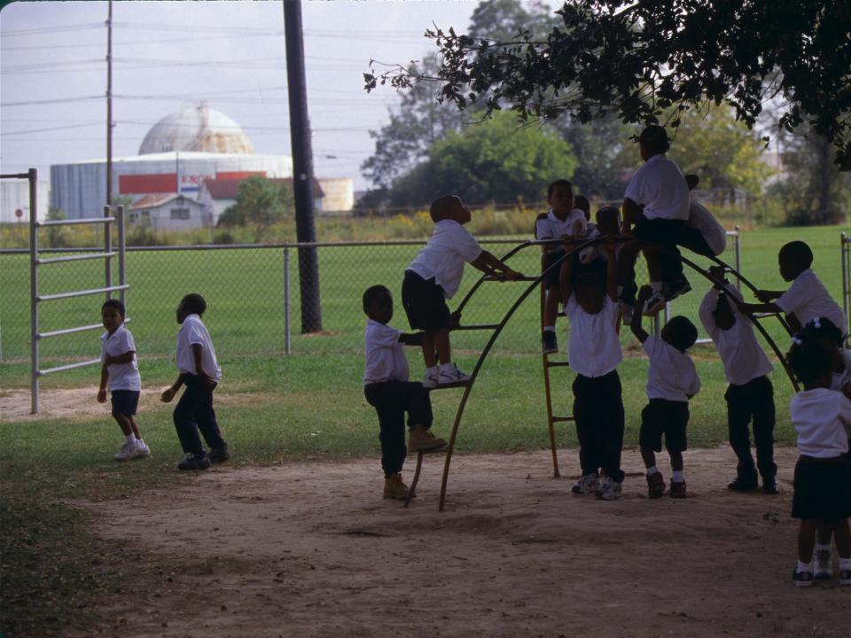 Oil and chemical refinery plants cover the landscape, next to African American communities along the Mississippi River, October, 1998, near Baton Rouge, Louisiana.