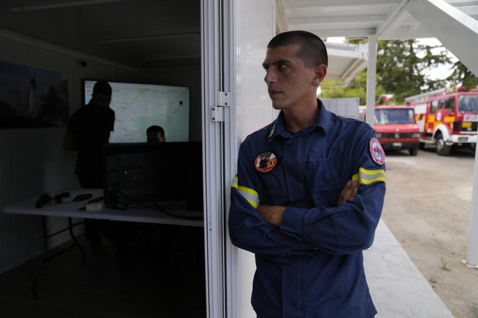 Giorgos Dertilis, who heads the local volunteer firefighters' unit, watches the screens at the drone control room, in the northern suburb of Nea Erithrea, Athens, Greece, Thursday, Aug. 10, 2023. Greece is plagued by hundreds of wildfires each summer. To protect their area from potentially deadly blazes, a group of residents from a suburb in northern Athens have joined forces to hire a company using long-range drones equipped with thermal imaging cameras and a sophisticated early warning system to catch fires before they can spread. (AP Photo/Thanassis Stavrakis)