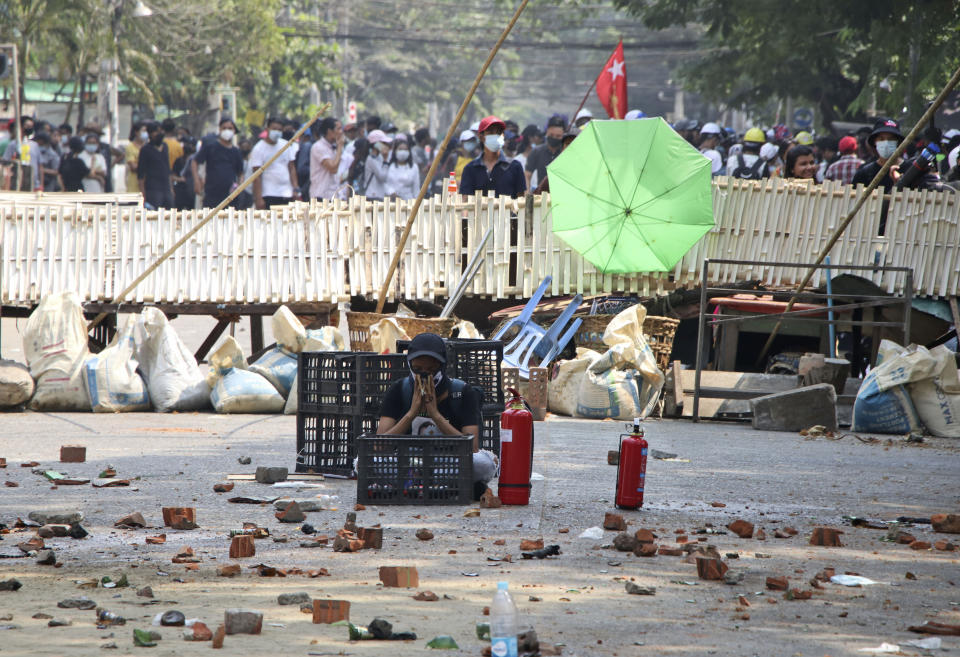 Anti-coup protesters stand behind a barricade during a demonstration in Dala township, Yangon, Myanmar, Saturday, March 27, 2021. As Myanmar’s military celebrated the annual Armed Forces Day holiday with a parade Saturday in the country’s capital, soldiers and police elsewhere reportedly killed dozens of people as they suppressed protests in the deadliest bloodletting since last month’s coup. (AP Photo)