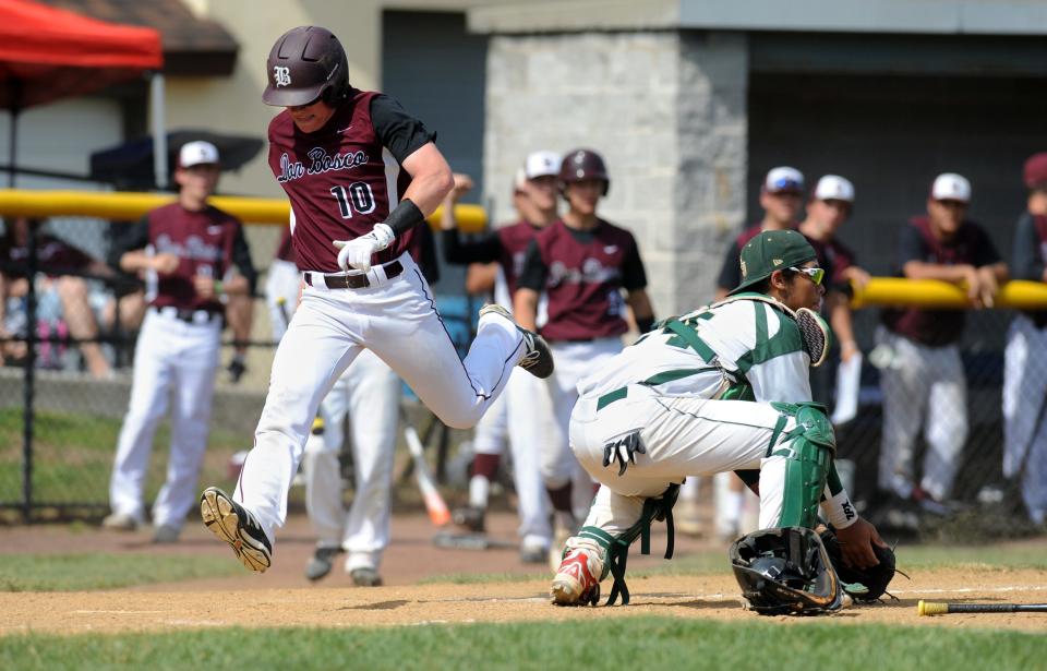 Demarest, N.J. Monday, May 26, 2014 -- Don Bosco's Brian Meerholz crosses home plate while St. Joseph's catcher Isaias Quiroz #24 waits for the throw. Don Bosco scored 4 runs in the 6th and won the Bergen County baseball tournament final, 7-1 over St. Joseph. AMY NEWMAN/STAFF PHOTOGRAPHER