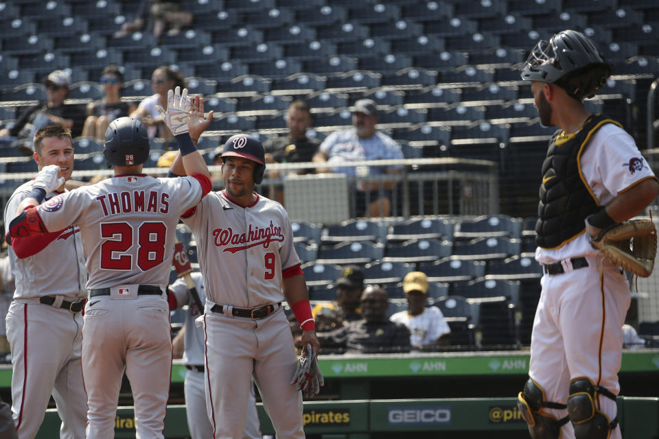 Washington Nationals' Patrick Corbin (46), Lane Thomas (28) and Adrian Sanchez (9) celebrate after Thomas hit a home run that scored them in the fourth inning during a baseball game against the Washington Nationals, Sunday, Sept. 12, 2021, in Pittsburgh. (AP Photo/Rebecca Droke)