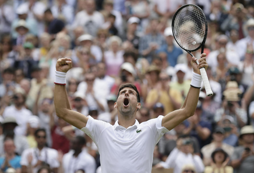 Serbia's Novak Djokovic celebrates defeating Belgium's David Goffin during a men's quarterfinal match on day nine of the Wimbledon Tennis Championships in London, Wednesday, July 10, 2019. (AP Photo/Tim Ireland)