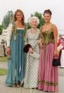 <p>In 2001, the Swedish royal family hosted a multi-day celebration to honor the 25th wedding anniversary of King Carl XVI Gustaf and Queen Silvia. Here, Madeleine and Victoria wore traditional Swedish ensembles at one of the events, smiling for a photo with their relative, Princess Lilian, Duchess of Halland.<br></p>