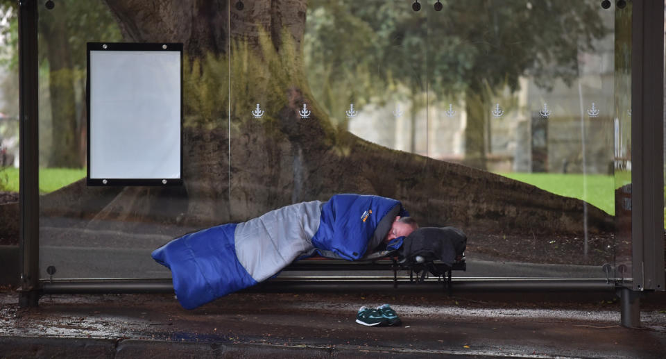 Man sleeping on Sydney bench. 