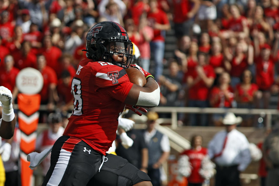 Texas Tech's Tahj Brooks (28) runs to score a touchdown during the first half of an NCAA college football game against West Virginia, Saturday, Oct. 22, 2022, in Lubbock, Texas. (AP Photo/Brad Tollefson)