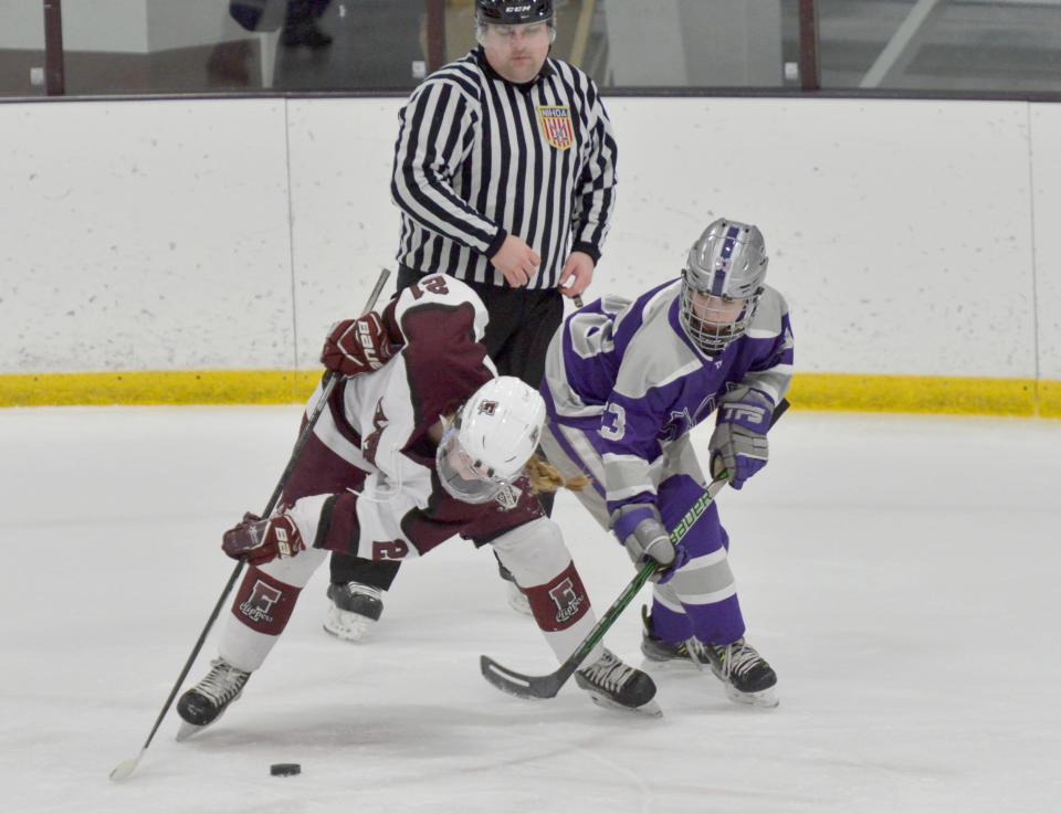 Falmouth's Maeve Turner, left, and Martha's Vineyard Emily Coogan go after the puck in a face-off during first period action.
(Photo: Merrily Cassidy/Cape Cod Times)