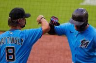 <p>Miguel Rojas #19 of the Miami Marlins reacts with manager Don Mattingly #8 after hitting a solo homer in the third inning against the Atlanta Braves during an exhibition game at Truist Park on July 21 in Atlanta.</p>