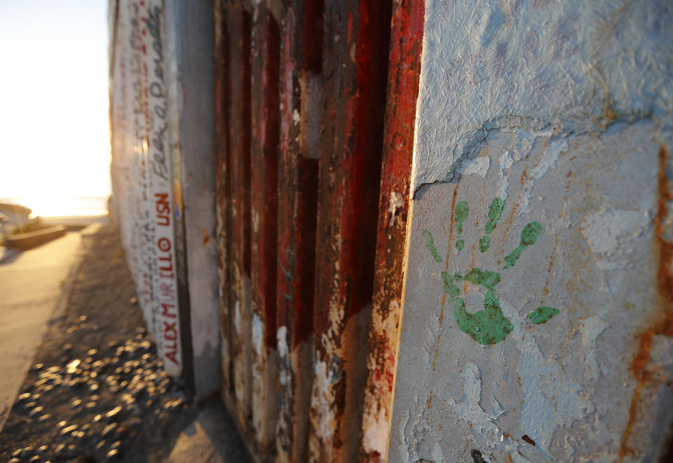 A hand print in honor of migrants that have been killed or are missing is seen on a border wall structure separating Tijuana, Mexico from San Diego, in Tijuana on Oct. 16, 2018. An Associated Press tally has documented at least 56,800 migrants dead or missing worldwide from 2014 to 2018 _ almost double the number found in the world's only official attempt to count them, by the U.N.'s International Organization for Migration. (AP Photo/Gregory Bull)