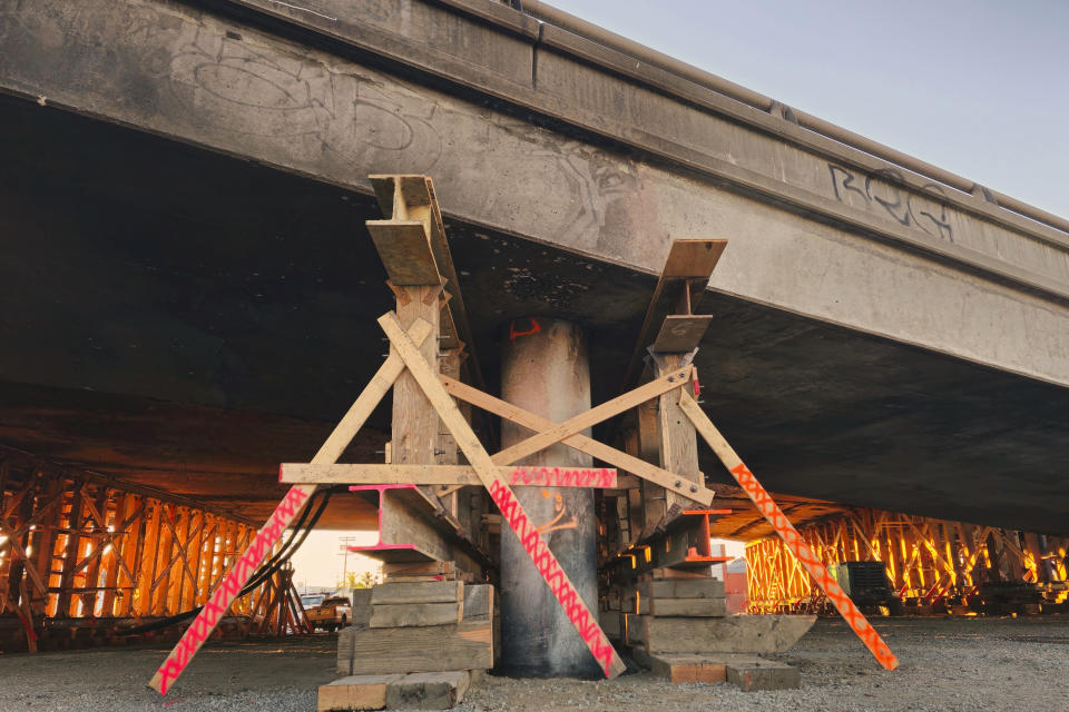 Structural supports hold the burned section of Interstate 10 in Los Angeles, Saturday, Dec. 9, 2023. (AP Photo/Damian Dovarganes)