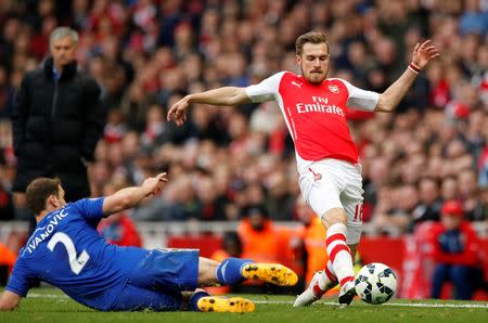 Football - Arsenal v Chelsea - Barclays Premier League - Emirates Stadium - 26/4/15 Arsenal's Aaron Ramsey in action with Chelsea's Branislav Ivanovic Action Images via Reuters / John Sibley Livepic EDITORIAL USE ONLY. No use with unauthorized audio, video, data, fixture lists, club/league logos or "live" services. Online in-match use limited to 45 images, no video emulation. No use in betting, games or single club/league/player publications. Please contact your account representative for further details.