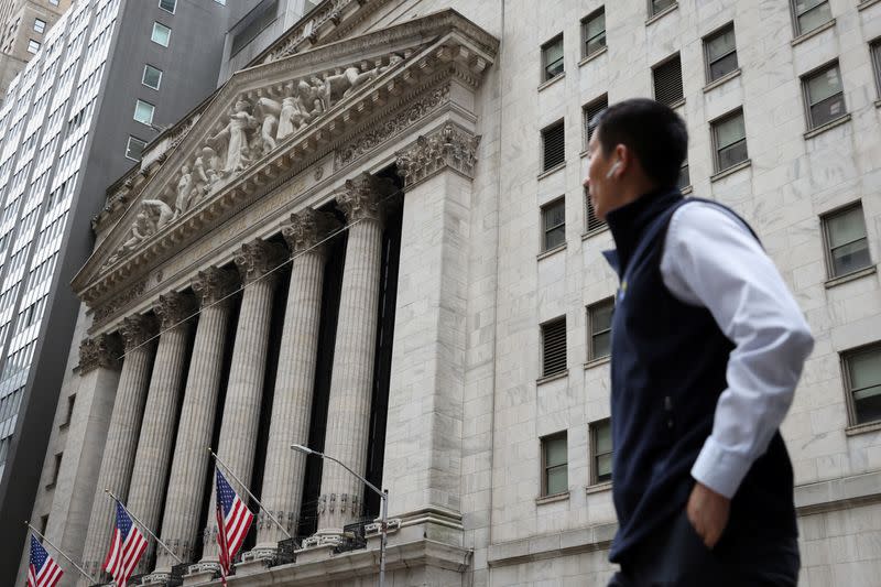 A person walks by the New York Stock Exchange (NYSE) in Manhattan, New York City