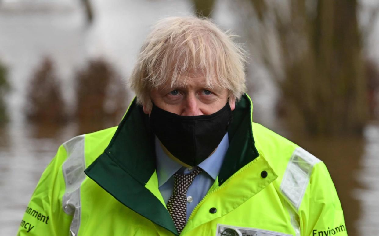 Britain's Prime Minister Boris Johnson talks with local residents who were evacuated from their properties overnight, during his visit to the Withington Golf Club in Withington, Manchester - PAUL ELLIS /AFP