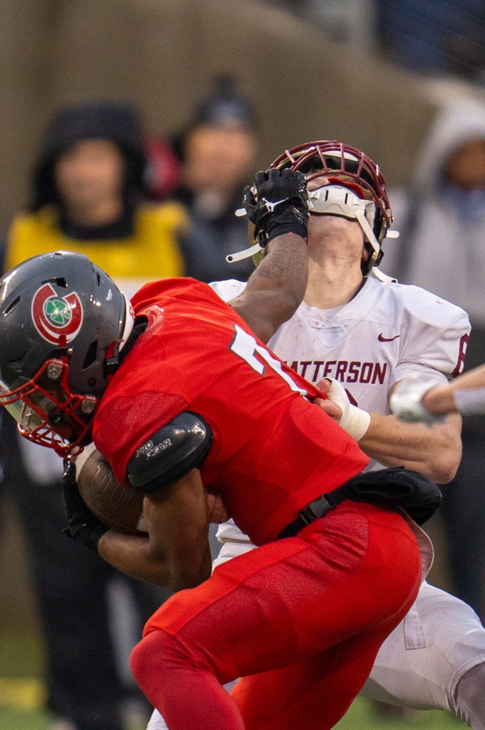 Watterson's Dominic Purcell attempts to tackle Toledo Central Catholic's Tyler Morgan during the Division III state final Friday at Tom Benson Hall of Fame Stadium in Canton.