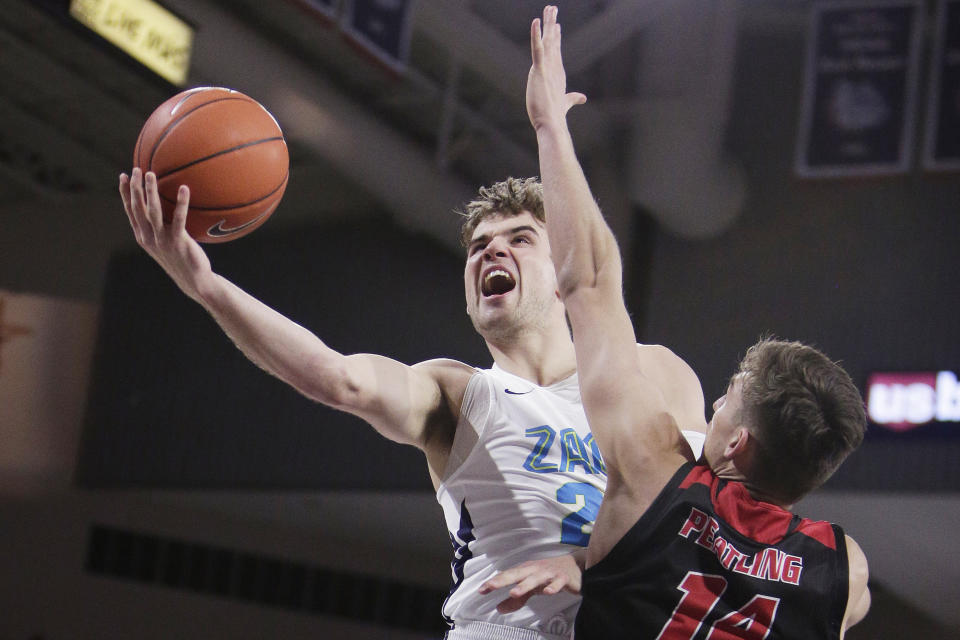 Gonzaga forward Corey Kispert, left, shoots and is fouled by Eastern Washington forward Mason Peatling during the second half of an NCAA college basketball game in Spokane, Wash., Saturday, Dec. 21, 2019. Gonzaga won 112-77. (AP Photo/Young Kwak)