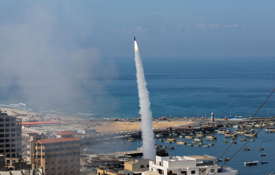 A rocket is fired by Palestinian militants from Gaza City toward Israel on Saturday. (Mohammed Salem/Reuters)
