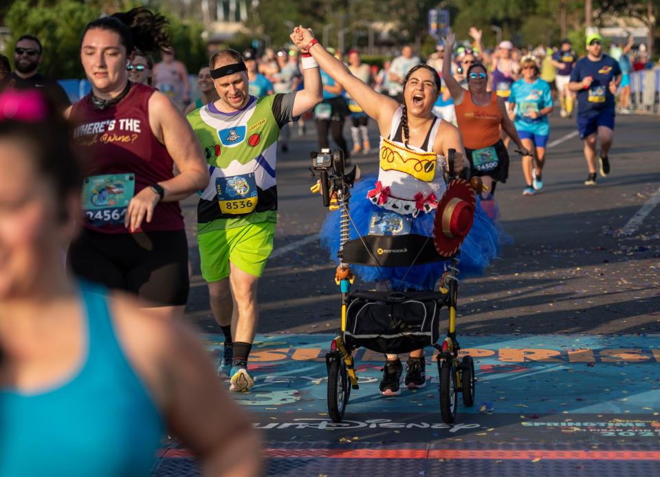 Nathalia Paradise of Tampa defied the odds when she completed the Disney Pixar Toy Story 10-Miler during runDisney Springtime Surprise Weekend on April 16, 2023, in Lake Buena Vista, Fla. The Army veteran recently suffered a severe spinal injury but overcame those difficulties by using a walker to successfully finish the final on-site race of the 2022-23 runDisney race season. (Kent Phillips, photographer) 