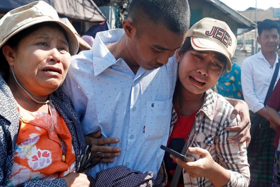 A man hugs family members upon his release from Insein prison in Yangon, Myanmar (EPA)