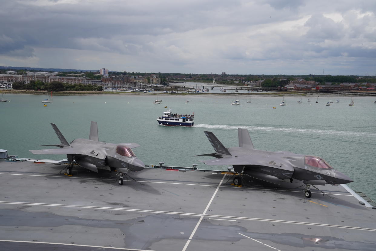 PORTSMOUTH, ENGLAND - MAY 22: A pair of F-35B Lightning II jets on the flight deck during Queen Elizabeth II's visit to HMS Queen Elizabeth at HM Naval Base ahead of the ship's maiden deployment on May 22, 2021 in Portsmouth, England. The visit comes as HMS Queen Elizabeth prepares to lead the UK Carrier Strike Group on a 28-week operational deployment travelling over 26,000 nautical miles from the Mediterranean to the Philippine Sea. (Photo by Steve Parsons - WPA Pool / Getty Images)