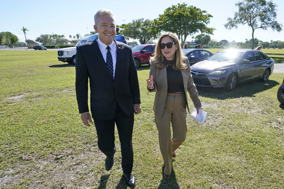 Former Rep. Debbie Mucarsel-Powell, D-Fla., right, chats with Navy Cmdr. (Ret.) Phil Ehr, as they walk to a news conference at the Memorial Cubano in Tamiami Park, Wednesday, Oct. 18, 2023, in Miami. Mucarsel-Powell, who is running for a Senate seat against Republican Rick Scott, endorsed Ehr for Congress. (AP Photo/Wilfredo Lee)