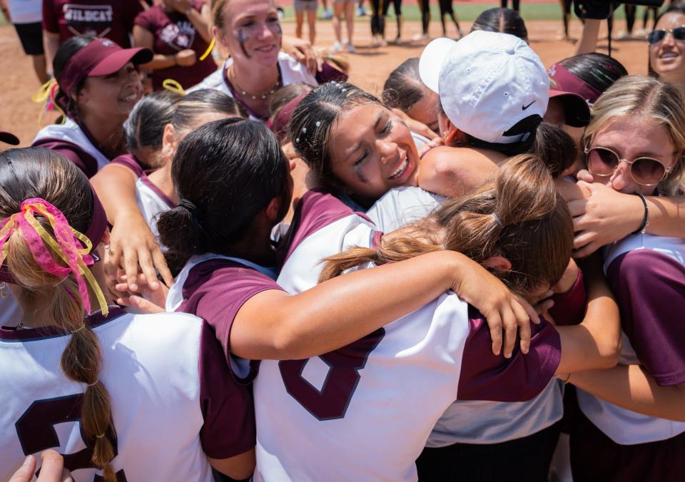 Calallen High School softball teammates embraces after their 9-7 win over Liberty High School in the State 4A UIL Championships at Red and Charline McCombs Field in Austin, June 3, 2023.