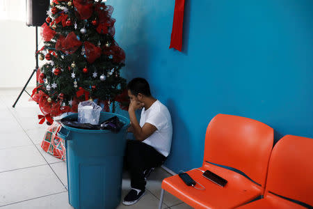 A deportee chat with his relatives at an immigration facility after a flight carrying illegal immigrants from the U.S. arrived in San Salvador, El Salvador, January 11, 2018. Picture taken January 11, 2018. REUTERS/Jose Cabezas