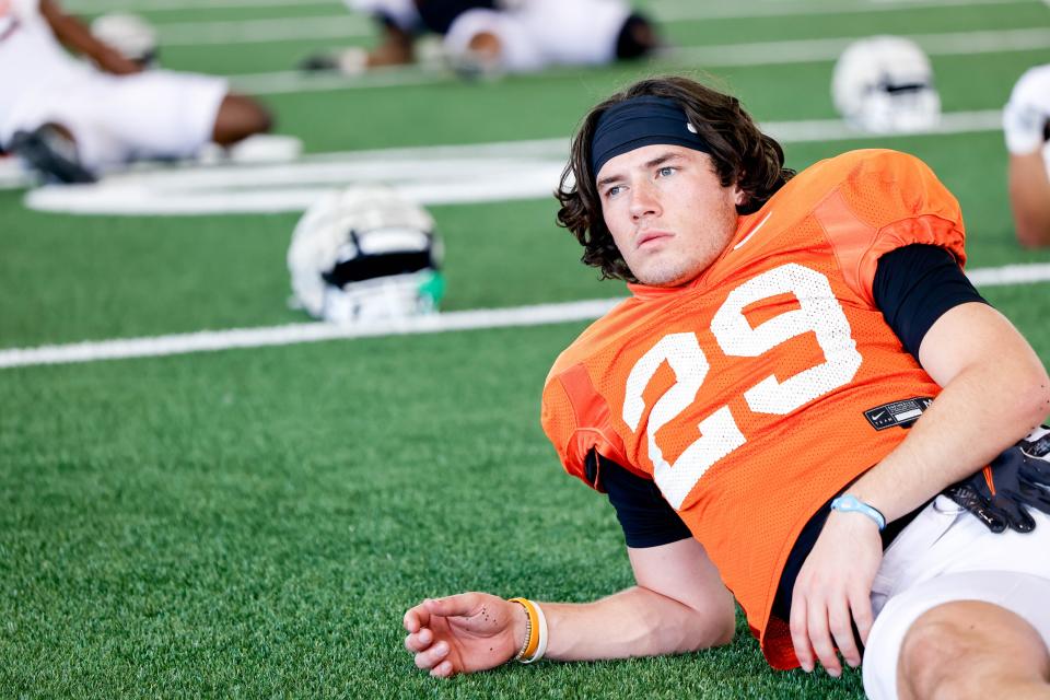 Hudson Kaak (29) stretches during an Oklahoma State football practice on Tuesday, April 23, 2024.