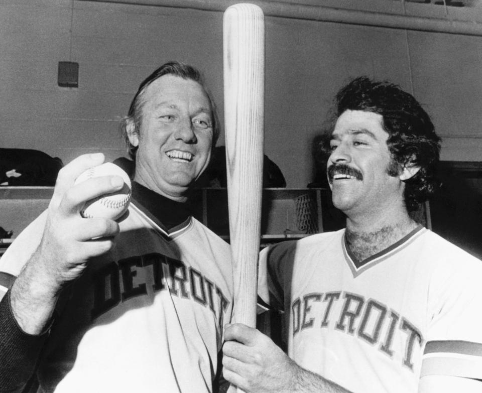 FILE - Al Kaline of the Detroit Tigers, left, shows his teammate Aurelio Rodriguez the bat and ball he used to hit his 3,000 hit in major league baseball in Baltimore, in this Sept. 24, 1974, file photo. The past year has not been good for 1970s baseball, with the deaths of a multitude of the decade's mainstays and heroes. Kaline died April 6, 2020. (AP Photo/William A. Smith, File)