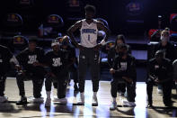 Orlando Magic's Jonathan Isaac (1) stands as others kneel before the start of an NBA basketball game between the Brooklyn Nets and the Orlando Magic Friday, July 31, 2020, in Lake Buena Vista, Fla. (AP Photo/Ashley Landis, Pool)