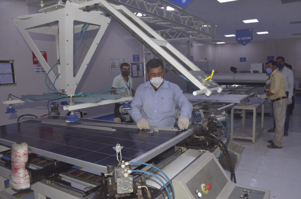 A file photo from June 2021 shows workers inside a solar photovoltaic panel manufacturing facility at Central Electronics Ltd. in Ghaziabad, India. / Credit: Sakib Ali/Hindustan Times/Getty