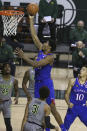 Kansas forward David McCormack (33) scores past Baylor guard Davion Mitchell (45) in the first half of an NCAA college basketball game, Monday, Jan. 18, 2021, in Waco, Texas. (AP Photo/Jerry Larson)