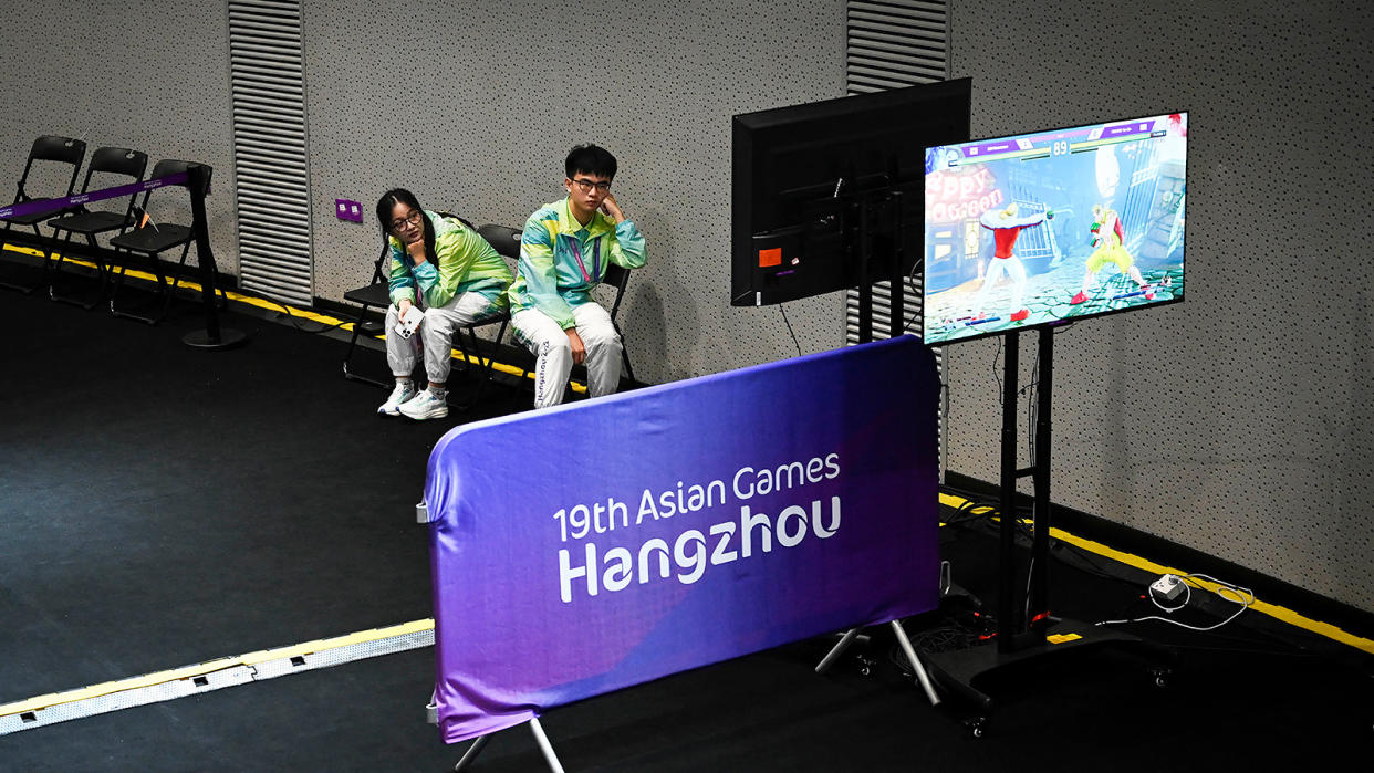 Volunteers watch the live stream of the Street Fighter V: Champion Edition final esports event during the Asian Games in Hangzhou. (Photo: AFP)