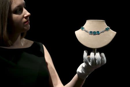 An employee holds an Art Deco diamond necklace, part of the collection of former British prime minister Margaret Thatcher during an auction preview at Christie's in London, Britain, December 11, 2015. REUTERS/Peter Nicholls