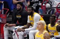 Los Angeles Lakers' Anthony Davis, Ben McLemore, Kyle Kuzma, front, and Dennis Schroeder watch play in the first half of an NBA basketball game against the Dallas Mavericks in Dallas, Thursday, April 22, 2021. (AP Photo/Tony Gutierrez)