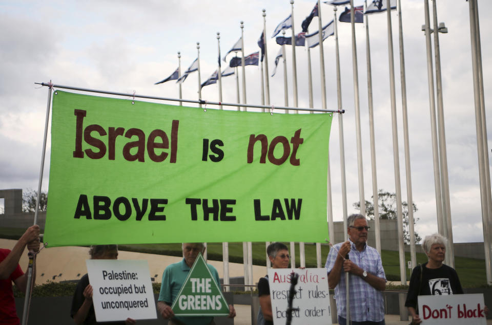 Around 50 pro-Palestinian demonstrators protest outside Parliament House in Canberra, Australia, on Wednesday, Feb. 26, 2020, ahead of Israeli President Reuven Rivlin's visit. The protest was organized by the Australia Palestine Advocacy Network which advocates for justice and peace for Palestinians. (AP Photo/Rod McGuirk)