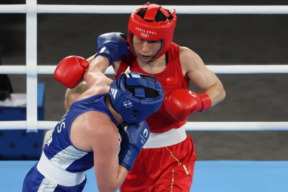 PARIS, FRANCE - AUGUST 08: Li Qian (red) of Team China competes against Caitlin Parker of Team Australia during the Boxing - Women's 75kg Semifinal on day 13 of the Paris 2024 Olympic Games at Stade Roland-Garros on August 8, 2024 in Paris, France. (Photo by An Lingjun/CHINASPORTS/VCG via Getty Images)