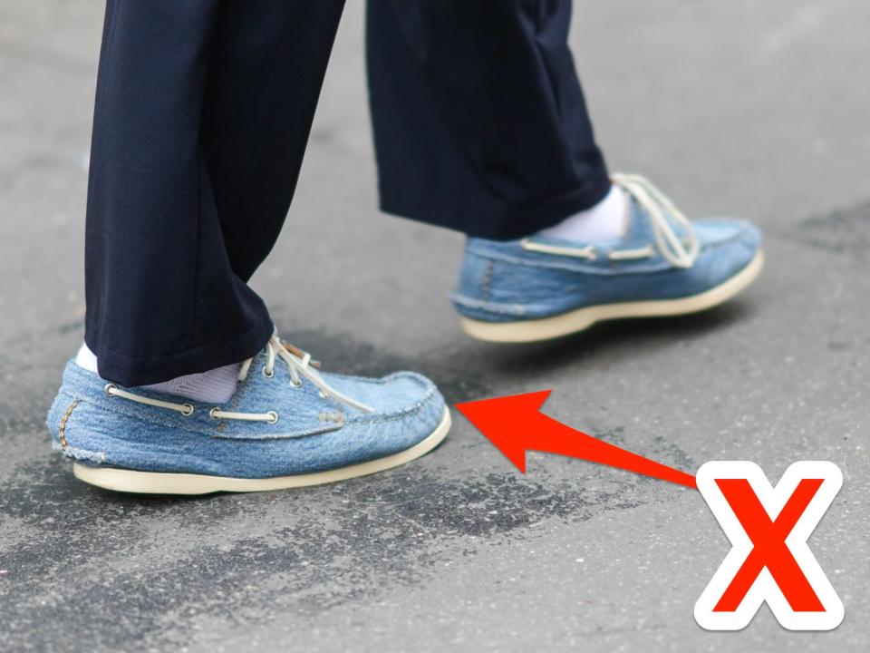 Denim boat shoes with an X pointing at them.