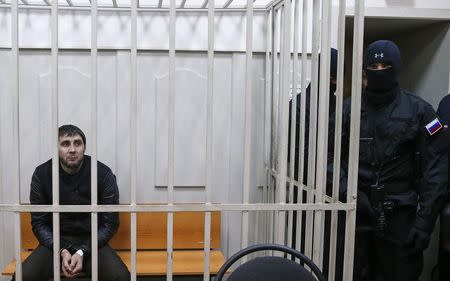 Zaur Dadayev (L), charged with involvement in the murder of Russian opposition figure Boris Nemtsov, looks out from inside a defendants' cage in a court building in Moscow, March 8, 2015. REUTERS/Tatyana Makeyeva