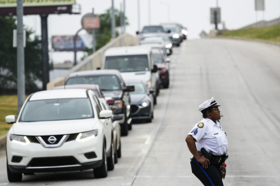 An officer directs traffic detoured from a collapsed elevated section of Interstate 95 in Philadelphia, Monday, June 12, 2023. (AP Photo/Matt Rourke)