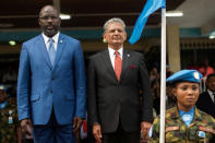 George Weah, Liberia's President and Farid Zarif, the Special Representative of the Secretary-General and Head of the United Nations Mission in Liberia (UNMIL), stand for the national anthem at the UNMIL headquarters in Monrovia during the ceremony to honour and farewell the police and military personnel who served with the UNMIL, in Liberia February 5, 2018. Albert Gonzalez Farran/UNMIL/Handout via REUTERS