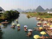 Bunte Sonnenschirme wie Farbtupfer in der Landschaft: Die Flößer bieten ihren Gästen etwas Schatten und laden zu einer gemächlichen Fahrt auf dem Fluss ein. Foto: Alexandra Frank