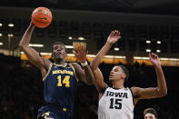 Michigan forward Moussa Diabate (14) drives to the basket ahead of Iowa forward Keegan Murray (15) during the first half of an NCAA college basketball game, Thursday, Feb. 17, 2022, in Iowa City, Iowa. (AP Photo/Charlie Neibergall)