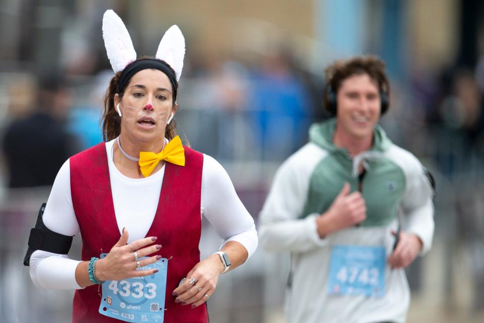 The Queen Bee Half Marathon takes place Saturday. Pictured: Rosanna Heinrichs runs while dressed as the white rabbit during the 2021 Queen Bee Half Marathon.