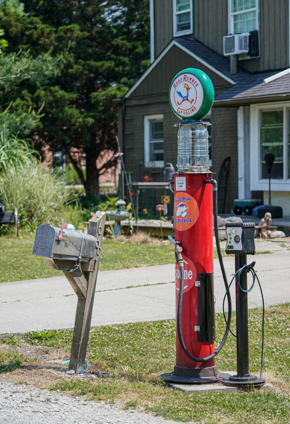 A, antique gas pump and antique automobilia brighten up a street in the Home Place neighborhood of Carmel Ind., on Thursday, June 8, 2023. 
