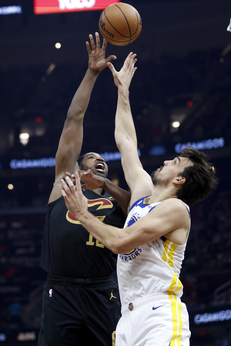 Cleveland Cavaliers center Tristan Thompson, left, shoots against Golden State Warriors forward Dario Saric, right, during the first half of an NBA basketball game, Sunday, Nov. 5, 2023, in Cleveland. (AP Photo/Ron Schwane)